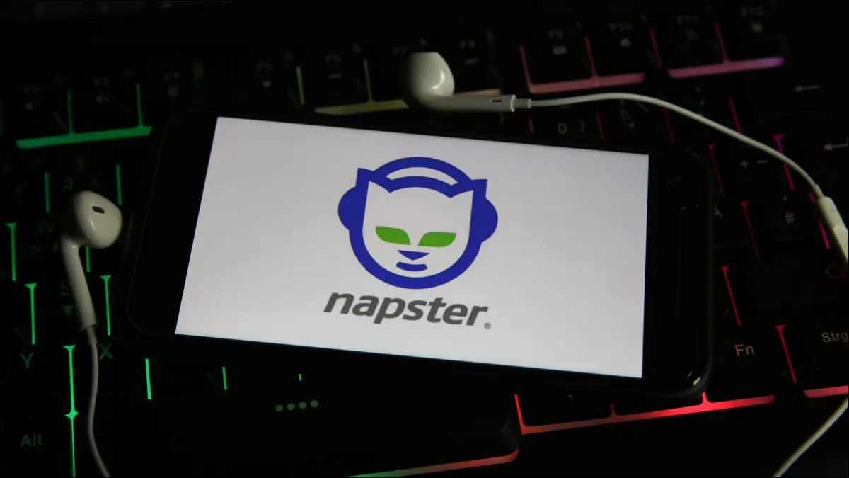 Smartphone yang menampilkan logo Napster dan dikelilingi oleh earbud yang terpasang.