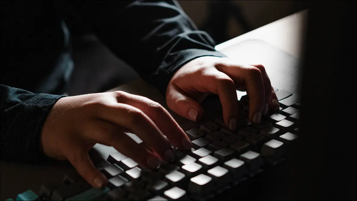 Personne tapant de façon inquiétante sur un clavier sombre