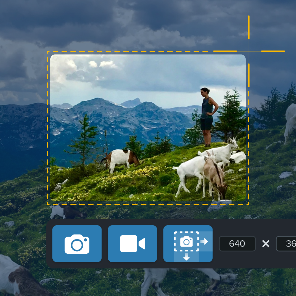 Alguien capturando una captura de pantalla de una escena de montaña con una persona y cabras usando Snagit, mostrando herramientas de recorte en la pantalla.